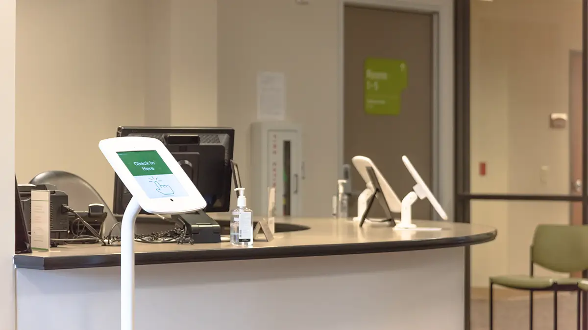 Patient using tablet for digital check-in at medical practice
