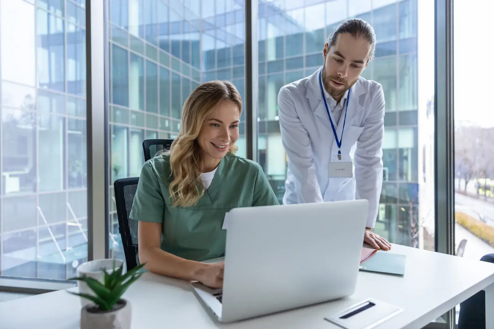 Healthcare professionals collaborating on technology solutions in a modern medical office